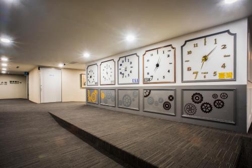a room with several clocks on the wall at XinsheHotel - Chungli in Zhongli