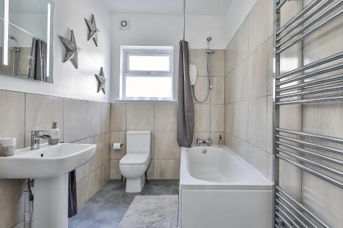 a bathroom with a sink and a toilet and a bath tub at Hidden Gem-Open To Book-Super Location in Sheffield