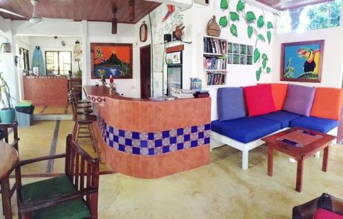 a living room with a couch and a table at Hotel Tropical Sands Dominical in Dominical