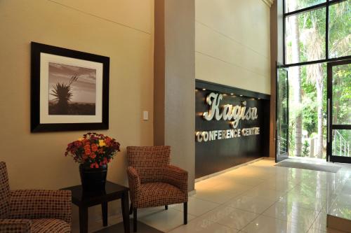 a lobby with chairs and a sign that reads steveston comeeat cafe at Safari Hotel & Convention Centre in Rustenburg