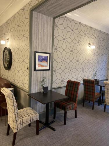 a waiting room with a table and chairs at Green Hotel in Kinross