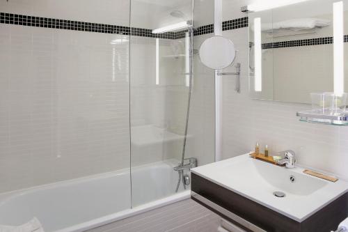 a bathroom with a sink and a shower at Logis Havvah Hôtel Gap in Gap