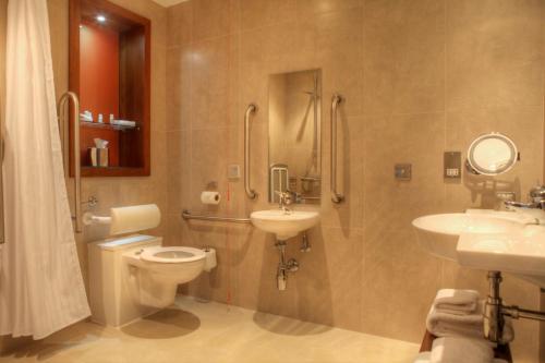 a bathroom with a toilet and a sink and a shower at Hotel Indigo Glasgow by IHG in Glasgow