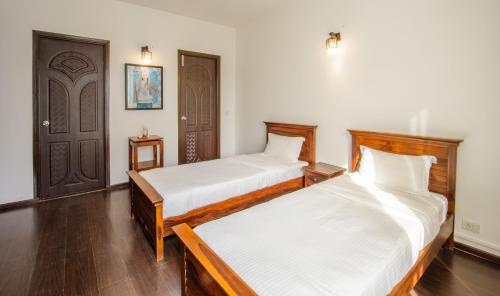 Katil atau katil-katil dalam bilik di Quill Residence - Candolim,Goa