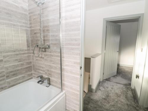 a bathroom with a shower and a sink at 11 The Forge in Brampton