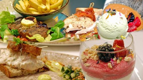 a table topped with a plate of food with a sandwich and french fries at Crowne Plaza Helsinki - Hesperia by IHG in Helsinki