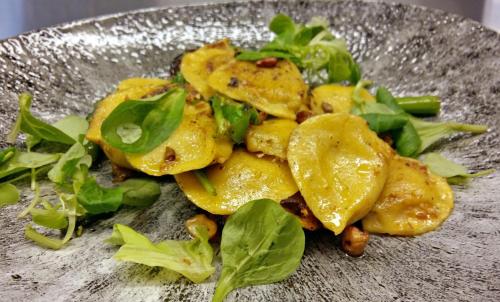 a plate of food with greens on it at Crowne Plaza Helsinki - Hesperia by IHG in Helsinki