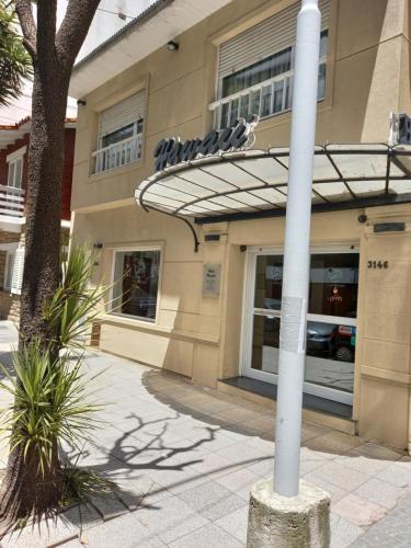 a white pole in front of a building at Hotel Hawaii in Mar del Plata