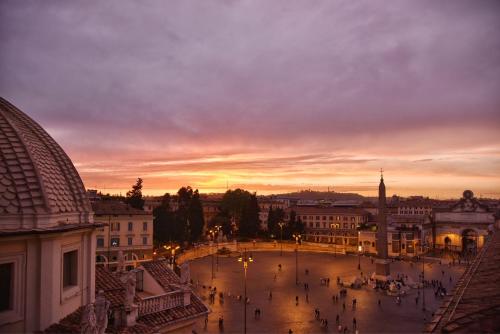 a view of a city at sunset at Rocco Forte Hotel De Russie in Rome