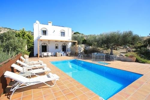 a villa with a swimming pool and a house at Villa Phaestias in Kalamaki Heraklion