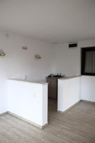 a white room with white walls and a table at Hățașul Bunicului in Arefu