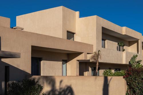 a building with a palm tree in front of it at Sirayane Boutique Hotel & Spa Marrakech in Marrakesh
