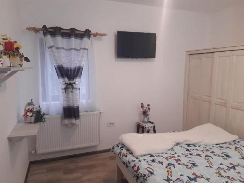 Postel nebo postele na pokoji v ubytování PENSIUNEA DODO