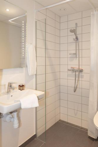 a bathroom with a sink and a shower at Skagen Hotel in Skagen