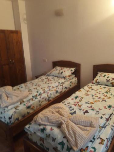 Postel nebo postele na pokoji v ubytování PENSIUNEA DODO