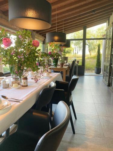 a restaurant with a long table with flowers on it at Podere Gattabigia in Lastra a Signa