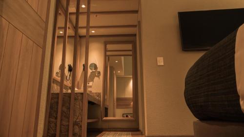 a hallway with a mirror and a television in a room at Termales Santa Rosa De Cabal in Santa Rosa de Cabal