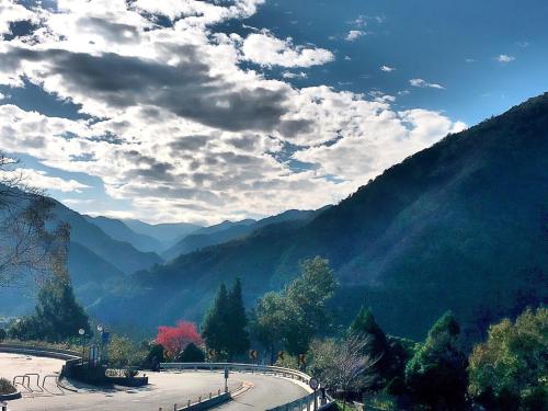 a view of a mountain with trees and a road at 溪景生態農莊 桃園市民宿037號 in Hualing