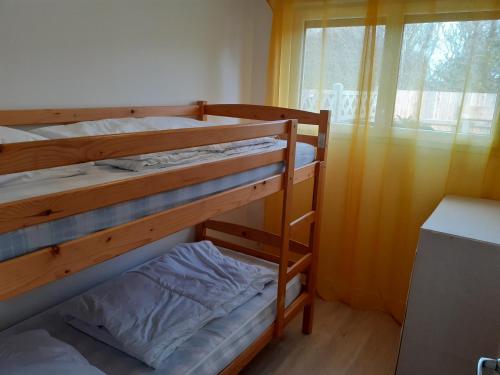 a bedroom with two bunk beds and a window at L'inattendu du D-Day in Port-en-Bessin-Huppain
