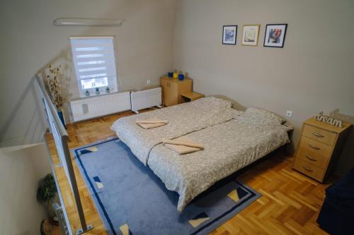 a bedroom with a bed and a blue rug at Košuta 21 Center Duplex Apartment, Brzeće in Brzeće