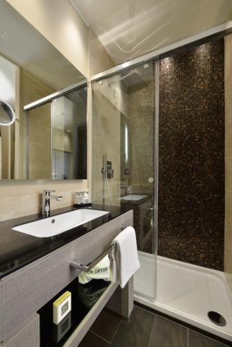 a bathroom with a tub and a sink and a shower at Rome Life Hotel in Rome