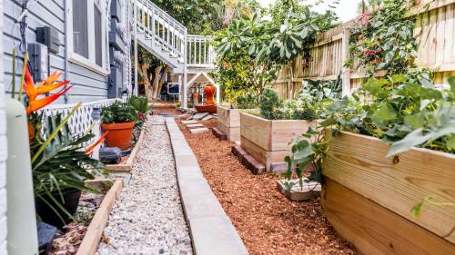 a garden in front of a house with plants at Meranova Guest Inn in Dunedin