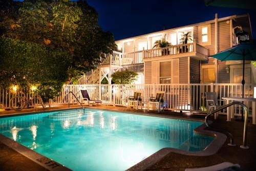 a swimming pool in front of a building at night at Meranova Guest Inn in Dunedin