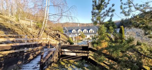 a view of a house from the hill with a wooden fence at hotel ZLATÝ POTOK in Nicov