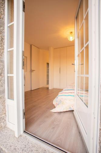 an open door to a bedroom with a bed at Fonte Velha in Castelões- Penafiel
