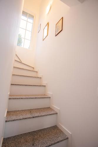 a staircase in a house with two pictures on the wall at Fonte Velha in Castelões- Penafiel