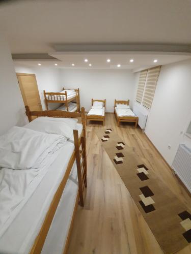 a bedroom with two bunk beds and a rug at Honey Valley Bjelašnica in Bjelašnica