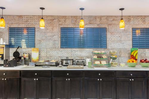 a kitchen with a counter with food on it at Quality Inn & Suites Goodyear - Phoenix West in Goodyear