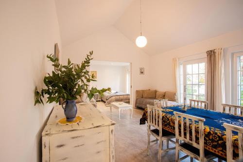 a living room with a table and chairs and a couch at Fonte Velha in Castelões- Penafiel