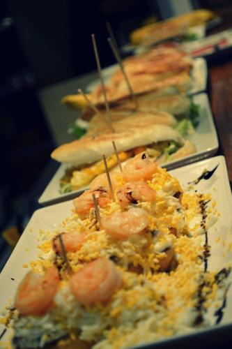 a plate of food with shrimp and rice on a table at Hotel Txartel in Lasarte