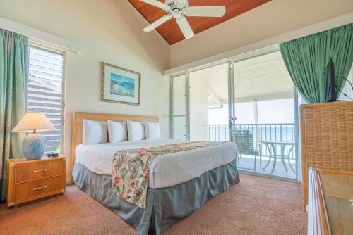 a bedroom with a bed and a balcony at Napili Sunset Beach Front Resort in Lahaina