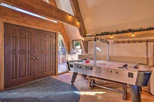 a room with a ping pong table in front of a door at Mtn Cabin Between Bryce Canyon and Zion Natl Parks! in Long Valley Junction