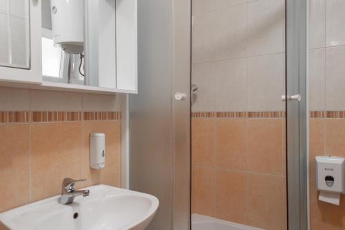 a bathroom with a sink and a shower at Promenada - Beachfront Apartments in Tučepi