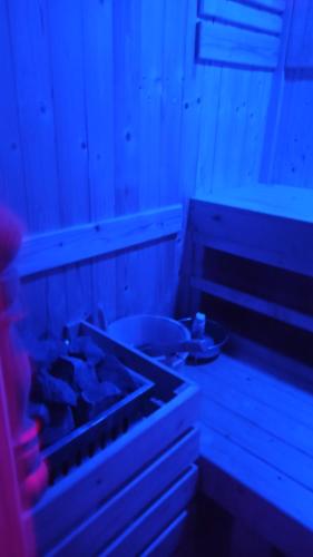 a room with a table with a blue light at Touch the Wind in Chaiyaphum
