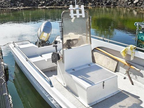 a dog sitting on a boat in the water at 6 person holiday home in Farstad-By Traum in Farstad