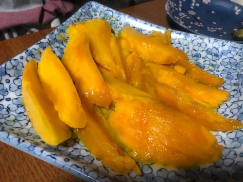 a plate of sliced up mangoes on a table at Happy Island Miyako in Miyako Island