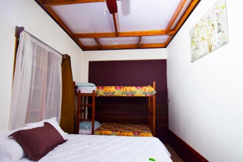 a bedroom with a bed and a bunk bed at |Hotel Riviera in Sabalito
