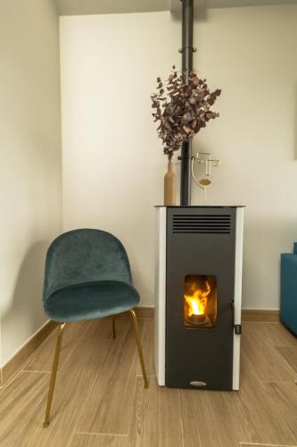 a chair and a stove in a room at Alto da Pousa in Tomiño