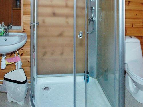 a shower with a glass door in a bathroom at 5 person holiday home in VÅGLAND in Bårdset