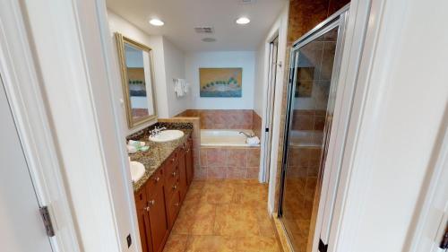 a bathroom with two sinks and a tub and a shower at Portofino Tower 3 Unit 1609 in Pensacola Beach