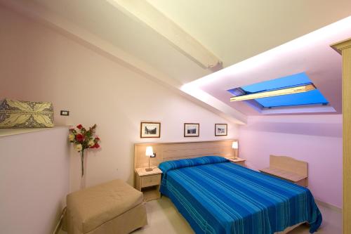 a bedroom with a bed and a skylight at Sorrento Belvedere B&B in Sorrento
