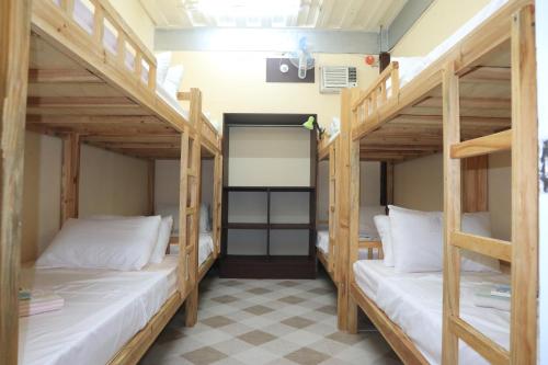 a room with two bunk beds in a hostel at Cool Martin Family Hotel and Resort in Bacoor
