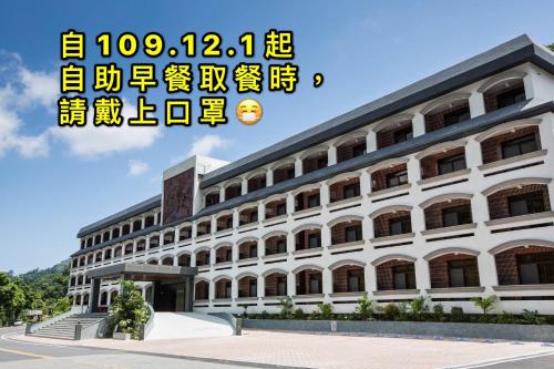 a large white building with a lot of windows at Dong Tair Spa Hotel in Wenquan