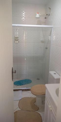 a bathroom with a shower and a toilet and a sink at Arraial do Cabo in Arraial do Cabo