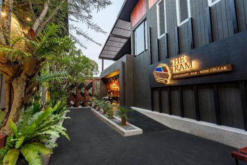 a building with a sign that reads the rain sustainable wet garden at The Gems Mining Pool Villas Pattaya in Nong Prue