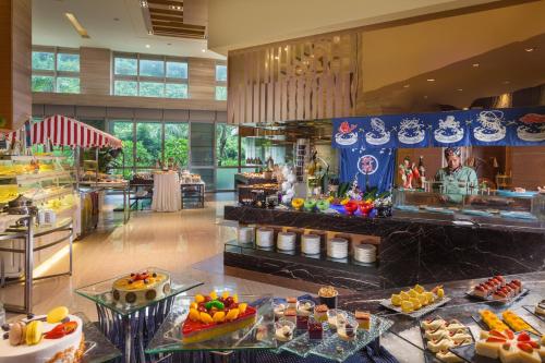 a buffet line in a restaurant with food on display at Junluxe Hotel Guangzhou Science City-Free Shuttle Bus Service to Guangzhou Canton Fair in Guangzhou
